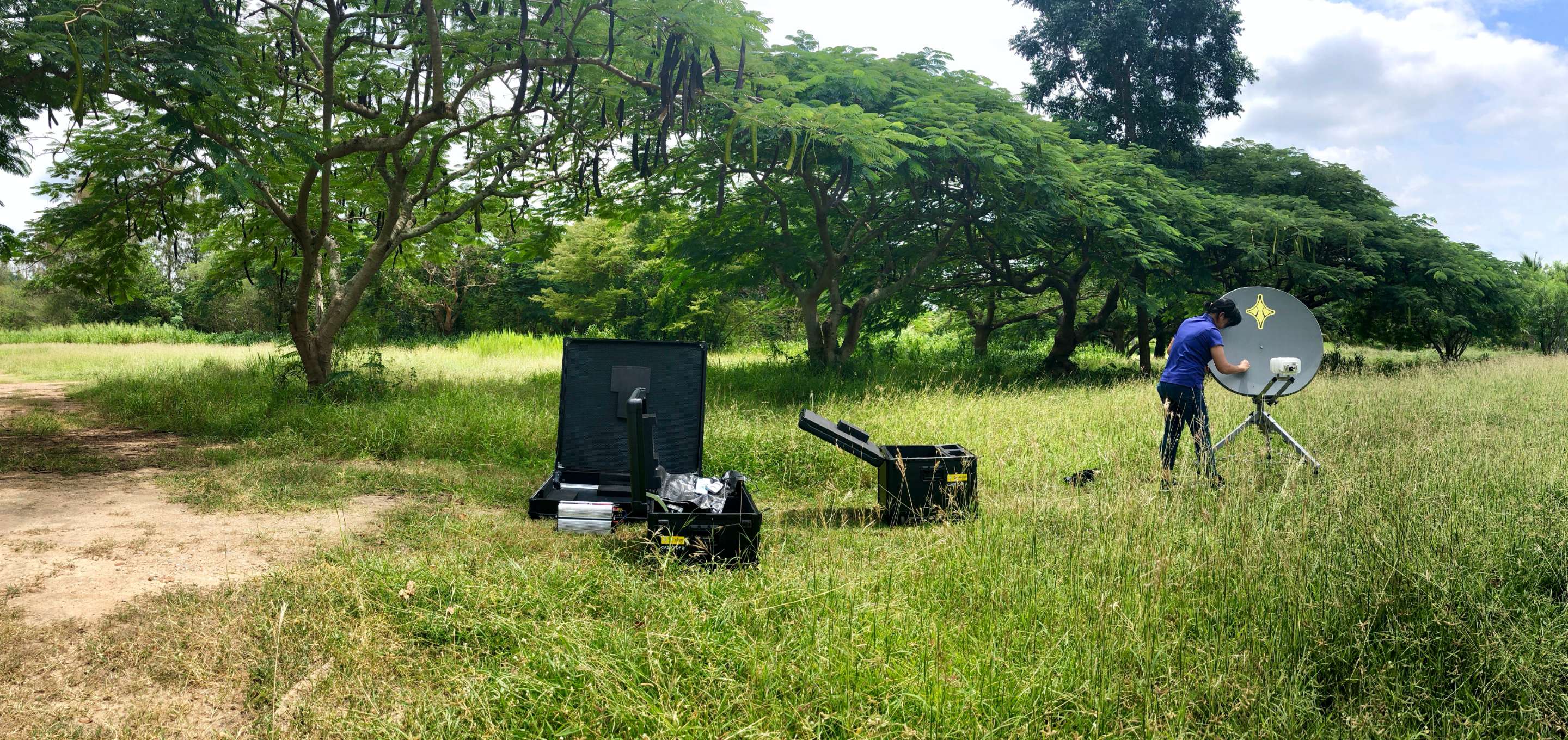 person setting up a satellite comms system