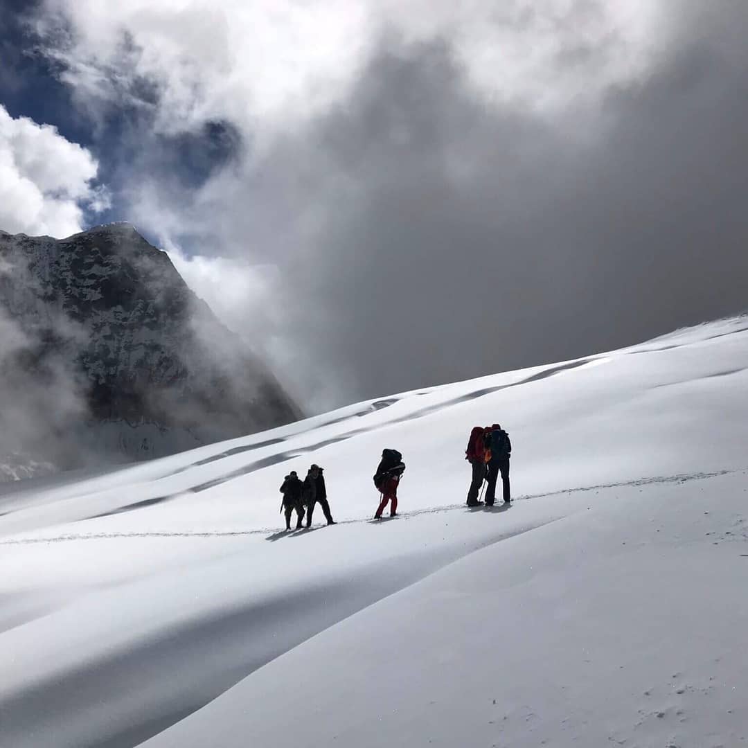 people hiking on a snowy mountain